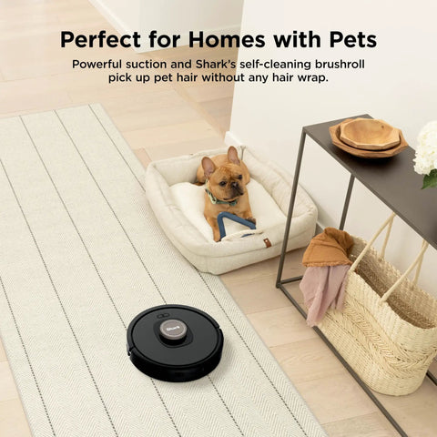 AI Robot Vacuum With XL Self Empty Base Mega Suction For Pet Hair Lidar Navigation Bagless 60 Day Capacity Alexa And WiFi Connected Cleans Carpet And Hard Floors Black in home setting with dog on bed.