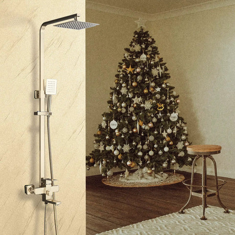 Dope Brushed Gold Shower System With Handheld Spray For Indoor Or Outdoor Use mounted on wall beside a Christmas tree.