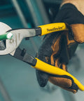 Tough Nine Inch Cable Cutter With Comfort Dipped Grips and Solid Forged Steel Arms cutting through green wire.