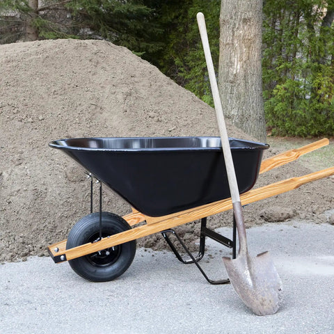 Wheelbarrow with 59 Inch Wood Wheelbarrow Handles Kit With Two Wedges, shown outdoors with a shovel; seal coat finish visible.