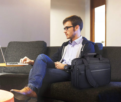 Expandable Water Repellent Laptop Briefcase For 17.3 Inch Laptop With RFID Pockets next to man using laptop on sofa