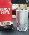 Workhorse Dual Run Round Capacitor 44 And 5 MFD 370V Or 440V next to Totaline HVAC/R parts box on table