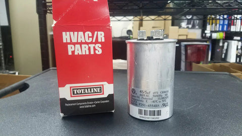 Workhorse Dual Run Round Capacitor 44 And 5 MFD 370V Or 440V next to Totaline HVAC/R parts box on table