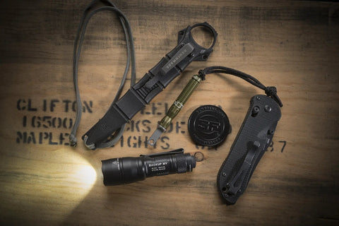 Dual Output LED Backup Flashlight With MaxVision Beam Technology for Everyday Carry with tactical gear on wooden surface