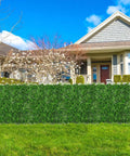 Artificial Hedge Wall Panels 20x20 Inch Boxwood Set, 12 Pieces installed outdoors as a lush privacy fence screen in a residential yard