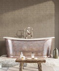 Taupe Metallic Grasscloth Peel And Stick Wallpaper Roll Featuring Faux Woven Texture With Subtle Shimmer in a bathroom setting.