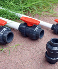 Union Ball Valve 1 Inch Full Port Pack of 2 UPVC Full Flow Ball Valves with 230 PSI Rating EPDM O Rings laying on the ground