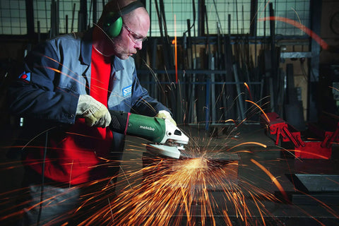 Worker using 9-Inch Angle Grinder With Lock-On Trigger, 6600 RPM, 15 Amp, W24-230 MVT for metalwork, sparks flying