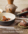 Nonstick Ceramic Cookware Set With Detachable Handle, 21 Pieces in use, charcoal finish, on table with bread and jug