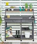 Outdoor Potting Bench Table All In One Garden Workstation With Drawer Adjustable Shelf Removable Sink in gray fir wood with plants