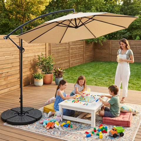 Heavy Duty Four Piece 13 Liter Water And Sand Filled Cantilever Offset Outdoor Umbrella Base Stand For Patio With Weather Resistant HDPE Construction In Black supporting umbrella over children playing.
