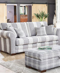 Striped sofa in living room with wooden sliding doors and solid wood furniture legs set with L shaped bed risers visible.