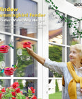 Woman installing Window Hummingbird Feeder Three Pack with strong suction cup, stainless steel base, 3.4 oz capacity per feeder