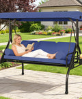 Woman relaxing on Three In One Outdoor Porch Swing Bed With Canopy Three Seat Patio Glider Cushioned Swing With Cup Holders in garden