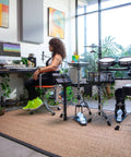 Woman producing music with TD-27KV2 Generation 2 V-Drum Kit With Flagship Sound next to her in a modern studio.