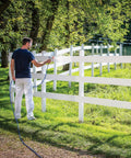 Heavy Duty Cart Paint Sprayer With Full Control Flow And RAC IV Switchtip For Thick Coatings Knocking Out Big Rental Jobs Without Breaking A Sweat, man spraying a fence outdoors.