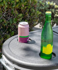 Close-up of a black 120-Qt Rolling Ice Chest Cooler Cart With Wheels And Drink Dividers, showing drink holder with soda can and bottle.