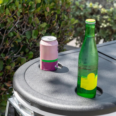 Close-up of a black 120-Qt Rolling Ice Chest Cooler Cart With Wheels And Drink Dividers, showing drink holder with soda can and bottle.