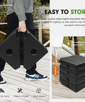 Person carrying Beefy Heavy Duty Patio Offset Umbrella Base Stand with 180 lb sand or water fill capacity, stackable design.
