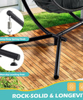 Close-up of Double Outdoor Hanging Egg Chair With Stand and Oversized Cushion, showcasing thick metal frame and sturdy foot.
