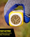 Person holding 6 oz container of pelleted mole and gopher bait with zinc phosphide for pest control in lawns and gardens