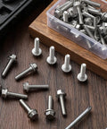 Top Pick 50 Pcs Of 1/4-20 X 1-1/4 Inch Stainless Steel Flanged Hex Bolts arranged on wooden surface.