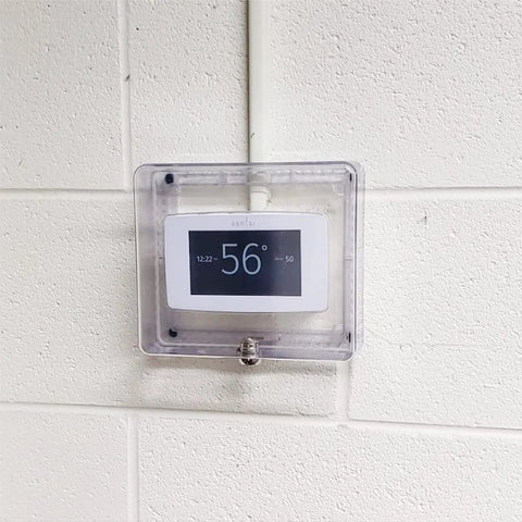Clear Plastic Low Profile Locking Thermostat Guard With Key For Wall Mounted Thermostat Cover on white wall