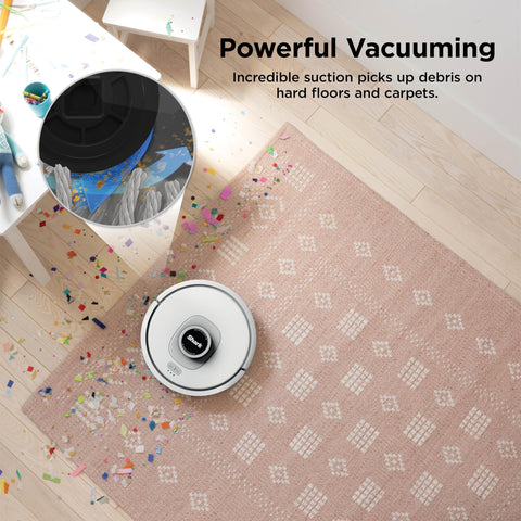 Matrix Clean Robot Vacuum With Serious Suction For Pet Hair On Carpets And Hard Floors Self Empty Base shown cleaning confetti on rug