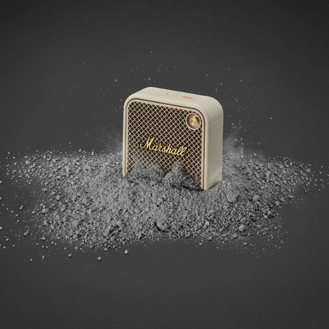 Willen II Portable Bluetooth Speaker With Rugged Waterproof And Dustproof Build, Cream Finish, surrounded by dust, close-up view