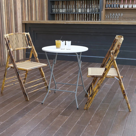 Two Foot Round Folding Event Table White Plastic Banquet Table For Indoor Outdoor Use set up with bamboo chairs on wooden deck