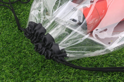 Close-up of Clear Drawstring Bags Two Pack, Waterproof Stadium Security Approved Small Clear Bags with black drawstring on grass.