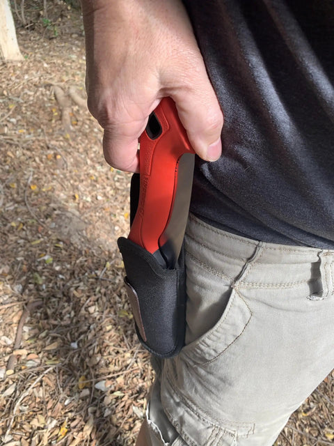 Close-up of a hand holding a 7 Inch Folding Pruning Saw With Fast Cut Razor Tooth Blade in a protective sheath.