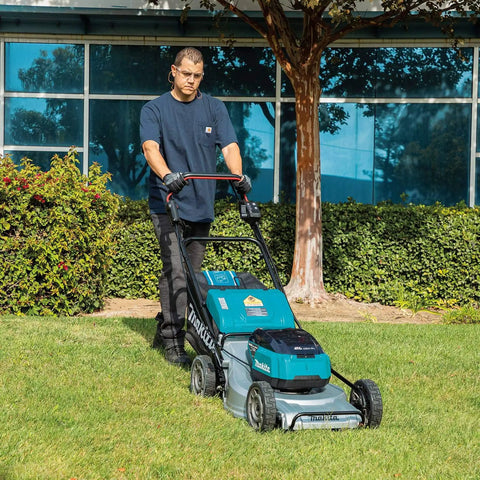 Pro Grade 21 Inch Cordless Self Propelled Lawn Mower steps up your yard game in a grassy area with a man operating it.