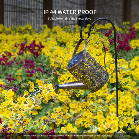 Copper Solar Watering Can Garden Light With Waterfall Effect and 60 LEDs over yellow flowers