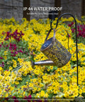 2 Pack Solar Waterfall Watering Can Lights For Garden hanging in garden with yellow flowers, copper design, LED copper outdoor stake lamp.