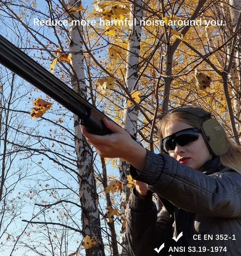 Person using Two Pack Shooting Ear Protection Earmuffs NRR 26dB for gun range and hunting in a forest in autumn.