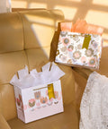 Two Pack 9 Inch Flower Gift Bags With Tissue Paper Featuring Tulip Floral Design Perfect For Mother's Day Gifts Birthdays Bridal Showers Easter And More Gift Wrapping Made Easy on chair.