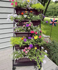Five Tier Vertical Garden Planter With Wheels For Indoor Outdoor Use featuring five planted container boxes outside a house.