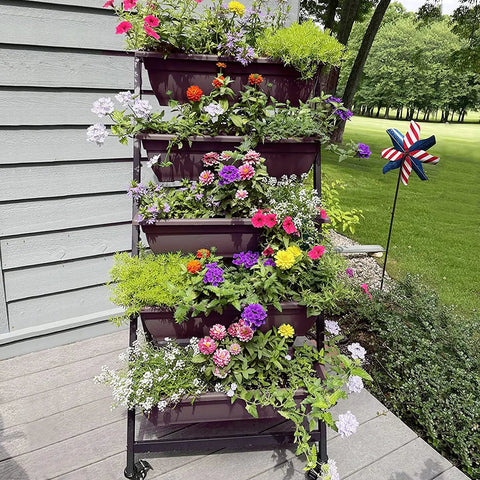 Five Tier Vertical Garden Planter With Wheels For Indoor Outdoor Use featuring five planted container boxes outside a house.