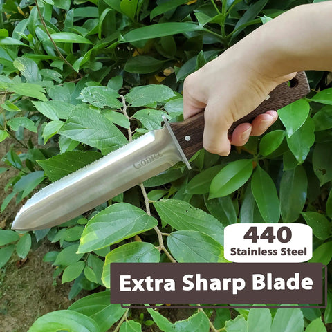Person holding Hori Hori Garden Knife with leather sheath and handguard Pro Grade 440 stainless steel blade in garden