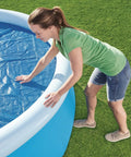 Hella Effective 10 Foot Solar Pool Cover That Locks In Heat And Shields Against Debris on an inflatable pool.