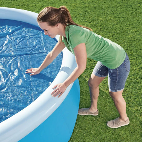 Hella Effective 10 Foot Solar Pool Cover That Locks In Heat And Shields Against Debris on an inflatable pool.