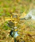 Rock Built Heavy Duty Brass Impact Sprinkler Head With Smooth 0 To 360 Degree Coverage Pattern For Big Time Patio Lawn Irrigation And Zero Drama Hose Hookup All Season, showing water spray.