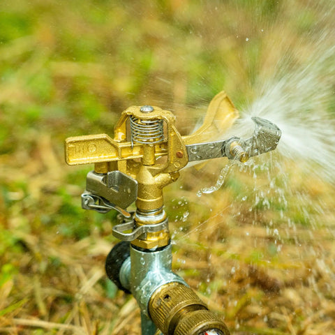 Rock Built Heavy Duty Brass Impact Sprinkler Head With Smooth 0 To 360 Degree Coverage Pattern For Big Time Patio Lawn Irrigation And Zero Drama Hose Hookup All Season, showing water spray.