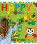 Child playing with Game Changing 812 Piece Building Blocks Kit Featuring Self Adhesive Wall Baseplates And Interconnected Marble Run Tracks.