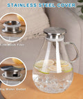 Premium Borosilicate Glass Pitcher With Lid 3000ml Hot And Cold Water Jug For Juices And Iced Tea Beverages Lead Free Eco Friendly Durable Carafe For Family Hangouts And Everyday Use displayed with stainless steel cover and infuser on a table.
