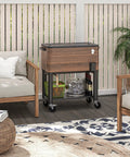 Brown rolling outdoor cooler cart with locking wheels, 60-quart capacity, steel frame, on patio next to seating area.