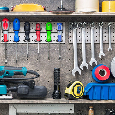 Pegboard Screwdriver And Tool Holder Rack Set With Six Ring Style Hooks For Pliers And Small Tools, Quick Clip On Mount, Durable Black Finish, Keeps Your Garage Neat And Gear Close At Hand shown installed on a wall with tools.