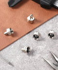 F Type Terminator Caps 5 Pack With 75 Ohm Resistor For Unused Coax Ports Signal Saver shown atop leather and concrete surfaces with tools