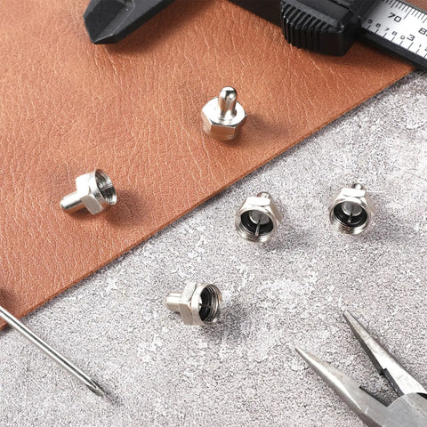 F Type Terminator Caps 5 Pack With 75 Ohm Resistor For Unused Coax Ports Signal Saver shown atop leather and concrete surfaces with tools